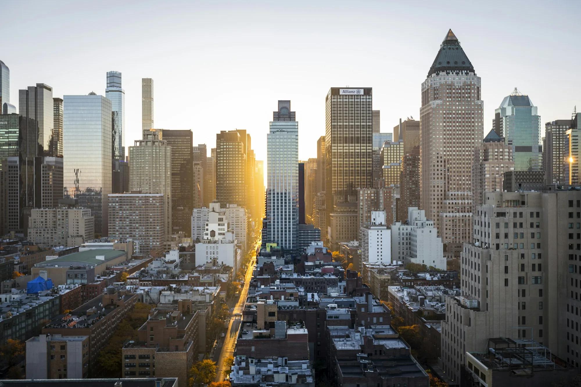 A dense city skyline at sunrise