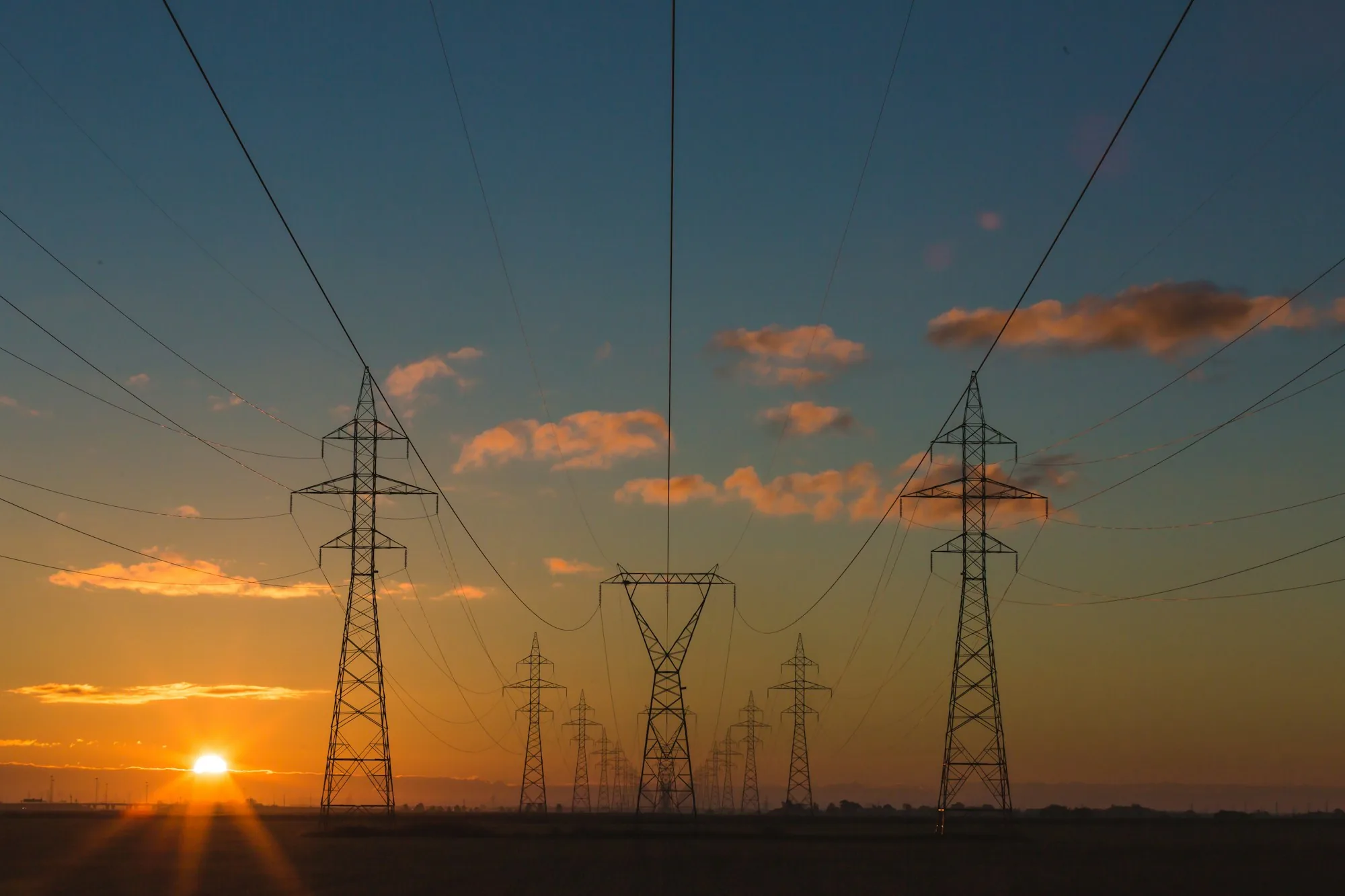 High-voltage transmission pylons at sunset